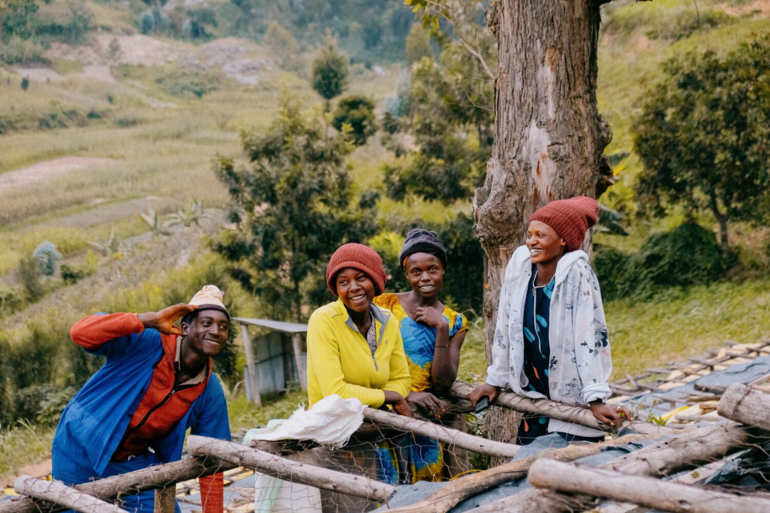A group of women standing by a coffee drying bed looking happy